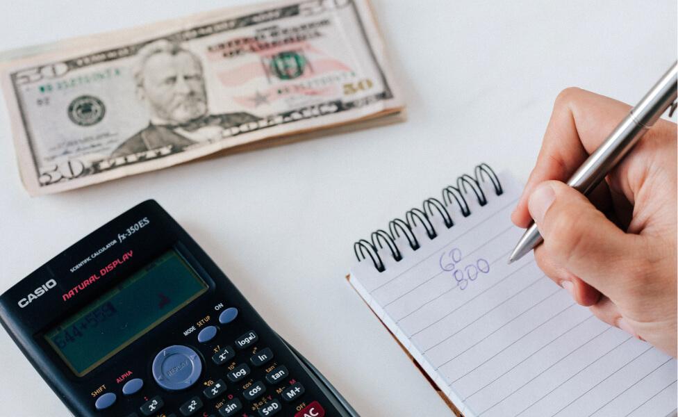 calculator and money laying on table