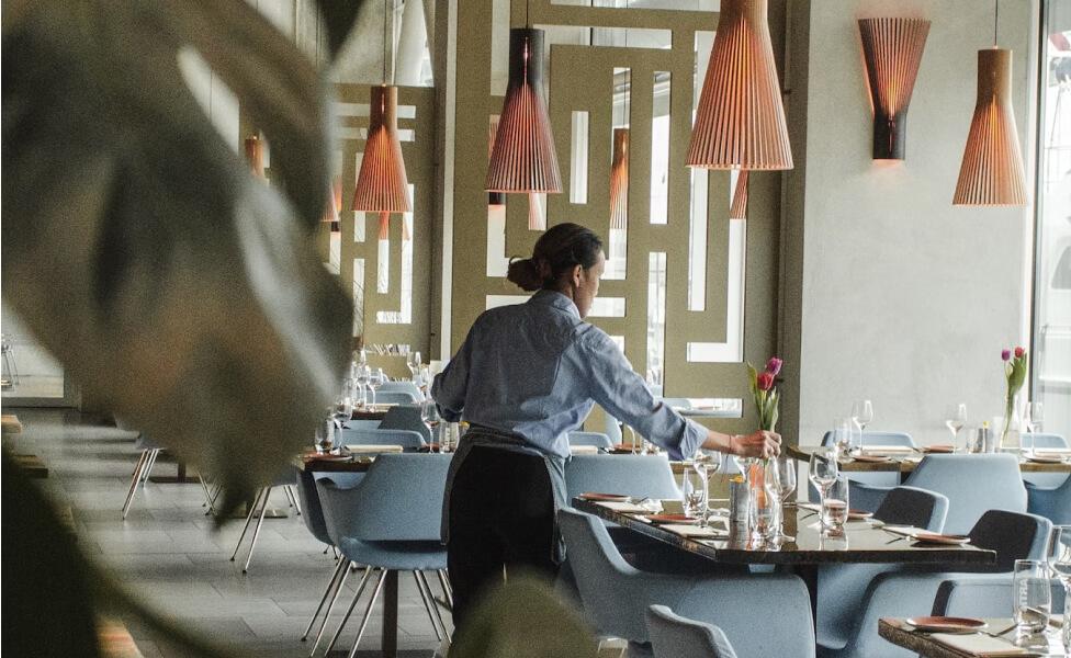 Server setting the table at a restaurant